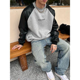 Ouzey Korean men's clothing with spliced leather sleeves and heavy contrast raglan sleeve sweatshirt with round neck and long sleeves